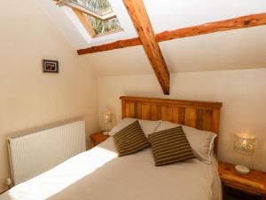 a bedroom with a bed with two pillows at 1 Mill Farm Cottages in Narberth