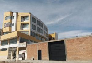 a brick building with a garage in front of it at The Oruro Inn in Oruro