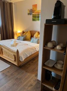 a bedroom with a bed and a book shelf at Pension Kulturhaus Niederau in Niederau