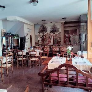 a restaurant with tables and chairs and a painting on the wall at "FUERTE " Affittacamere in Montevettolini