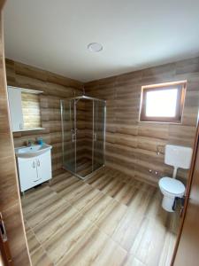 a bathroom with a shower and a toilet and a sink at Vikendica za odmor Laktasi in Laktaši