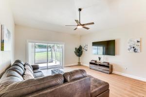 a living room with a couch and a ceiling fan at Valrico Home with Yard about 14 Mi to Downtown Tampa in Valrico