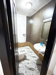 a bathroom with a toilet and a sink at Résidence jawharat mogador in Essaouira