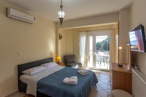 a bedroom with a bed with two towels on it at RENT HOUSE BEACH MIRTOFITO 8 km FROM PERAMOS in Elaiokhórion
