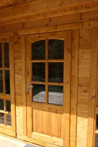 a wooden garage door with windows in a log cabin at Deer Meadow #1 in Maynooth