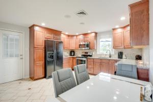 a kitchen with wooden cabinets and a table with chairs at Coopersburg Vacation Rental with Outdoor Oasis! in Coopersburg