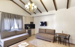 a living room with a couch and a table at Oasis Apartment Ammoudia in Ammoudia