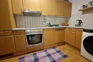 a kitchen with wooden cabinets and a stove top oven at Fewo Mima in Oberweissburg