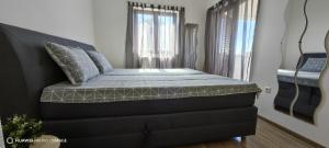 a bed sitting in a room with a window at Apartment Brioni Sea,Garden,Poll view 2 plus 2 80m2 tiki bar in Peroj +49 photos