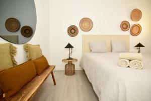 a bedroom with a bed and a chair and a mirror at Casa Lucia in Villaverde +33 photos