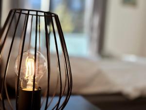 a close up of a lamp with a lit candle at BeeFree City Connect Metro Bus Shops Olympia in Munich
