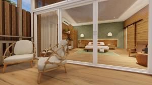モンテベルデ・コスタリカにあるMonteverde Lodge & Gardens by Böënaのベッドルーム1室(ベッド1台、椅子付)