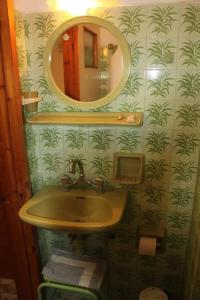 a bathroom with a sink and a mirror at Cozy double apartment near the sea in Tolo