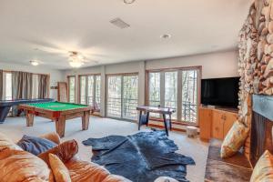 a living room with a pool table and a tv at Fairfield Bay Retreat with Fireplaces and Lake Access in Fairfield Bay