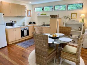 a kitchen with a table and chairs in a room at "La Petite Grange" Maleny in Maleny