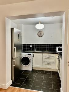 a kitchen with a washer and dryer in it at Saint Saviour's Apt Waterford in Waterford
