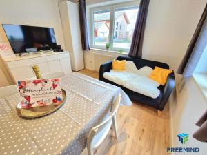 a small living room with a table and a chair at frisch modernisiertes Apartment in Altdorf +4 photos