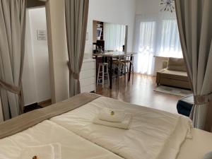 a bedroom with a bed with a towel on it at Rosebeach Appartement am Ossiachersee in Bodensdorf