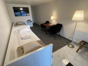 Habitación con cama, escritorio y mesa. en Vid Gekås Ullared Boende B&B, en Ullared