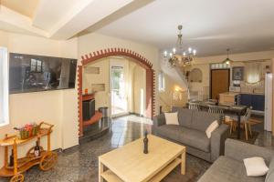 a living room with a couch and a table at RENT HOUSE BEACH MIRTOFITO 8 km FROM PERAMOS in Elaiokhórion