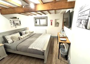 1 dormitorio con 1 cama y TV en la pared en Swallow Barn en Penrith