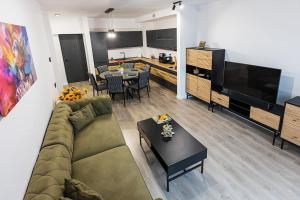 a living room with a couch and a table at Royal Family Apartment in Sinaia