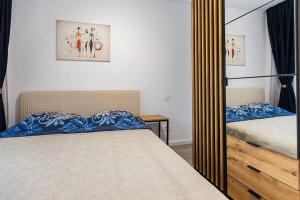 a bedroom with a bed and a mirror at Royal Family Apartment in Sinaia