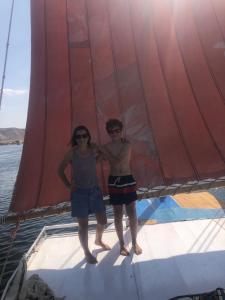 two people standing on a sail on a boat at King of love in Luxor