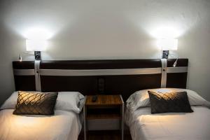 Voodi või voodid majutusasutuse HOSTAL LAS PALOMAS toas