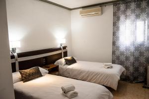 Voodi või voodid majutusasutuse HOSTAL LAS PALOMAS toas