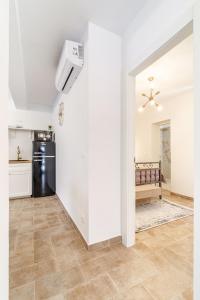 a kitchen with white walls and a refrigerator at House Josipa in Supetar
