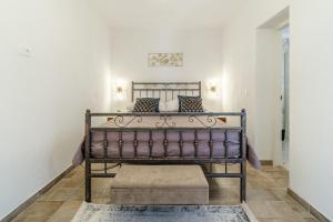 a bedroom with a metal bed in a room at House Josipa in Supetar