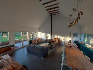 a living room with a couch and a table at Le quartier d'hiver, maison d'hôtes in Cléden-Cap-Sizun +17 photos