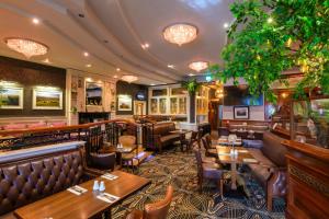 a restaurant with tables and chairs and a bar at Flagstaff Lodge in Newry