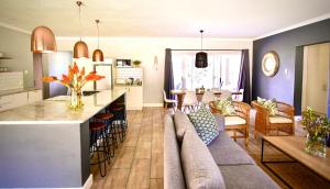 a living room with a couch and a kitchen at Saints Rest in Clarens