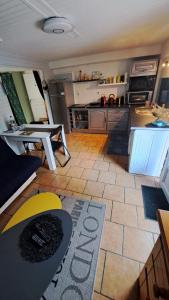 a kitchen with a table and a counter top at T1 bis indépendant dans maison individuelle in Albi