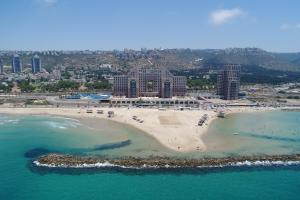 an aerial view of a beach with a resort at מגדל הים חיפה in Haifa