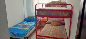 two bunk beds and a bed in a room at Ático Punta Umbría in Punta Umbría
