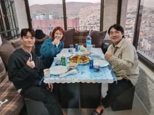 un grupo de personas sentadas en una mesa con comida en Sara apartment en Wadi Musa