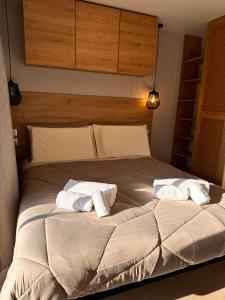 a large bed with two white pillows on it at Val di Venere Glamp House in Santa Maria in Stelle
