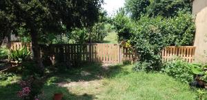 a wooden fence in a yard with a tree at Serendipity in Castelbelforte