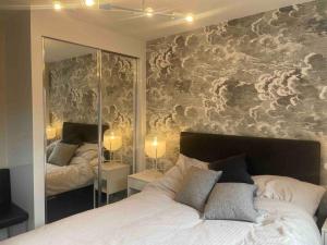 a bedroom with two beds and a large mirror at Stay@Chesterfield in Wingerworth