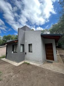 a house with a garage in front of it at Villa Simona in Santa Rosa de Calamuchita