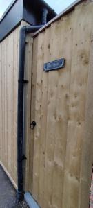 a wooden fence with a street sign on it at The Nook: Self Contained Annex in Taunton