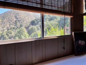 a window in a room with a view of a mountain at Cabaña ecológica y aislada in Santiago