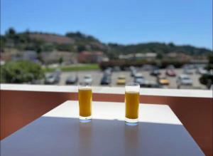 two glasses of beer sitting on top of a table at Alexandra's Apartments by Exclsv in Sidari