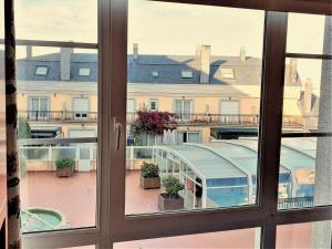 an open window with a view of a courtyard at Apartamentos SOL Y PLAYA Foz in Foz