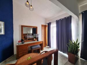 a living room with a desk and a mirror at Buena Vista Oceanfront & Hot Springs Resort in Buenavista