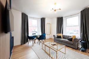 a living room with a couch and a table at Lamara Flat 1, Liverpool in Liverpool