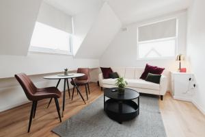 a living room with a couch and a table and chairs at Lamara Flat 1, Liverpool in Liverpool